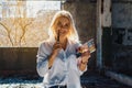 Woman in a white shirt takes notes in a notebook, looks into the camera Royalty Free Stock Photo