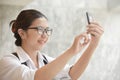 Woman in white shirt taking photo. Royalty Free Stock Photo