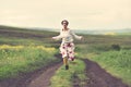 Woman in white skirt running on a countryside road Royalty Free Stock Photo