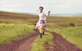 Woman in white skirt running on a countryside road Royalty Free Stock Photo