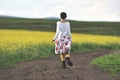 Woman in white skirt running on a countryside road Royalty Free Stock Photo