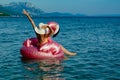 Woman with white straw hat on Flamingo floatie Royalty Free Stock Photo