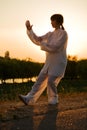 Woman in white suit make's taiji chuan - 10