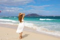 Woman in white sundress looking people doing kitesurfering sport while walking on Corralejo Dunes beach, Fuerteventura, Canary Royalty Free Stock Photo