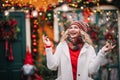 Woman in white sute red .pullover smiling in new year decoration near home with bright light