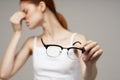 woman in white t-shirt glasses vision problems myopia