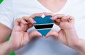 Woman in white t-shirt holds a heart in the form flag Botswana on her chest.