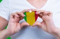 Woman in white t-shirt holds a heart in the form flag Mali on her chest.