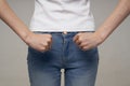 woman in white t-shirt and jeans thinness diet health problems