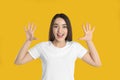 Woman in white t-shirt showing number ten with her hands on yellow background Royalty Free Stock Photo