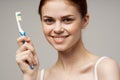 woman in white t-shirt toothbrush smile health and hygiene