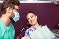 Woman with white teeth and male dentist smiling each other