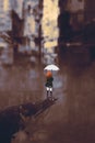 Woman with white umbrella in ruined city