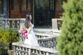 A woman with white wedding dress carry bridal bouquet stand in a cloister in shui bo park of Shanghai Royalty Free Stock Photo