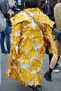 Woman with white and yellow coat with roses design before Fila fashion show, Milan Fashion Week