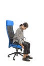 Woman who adjusts her ergonomic chair in the office