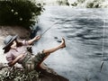 Woman who caught a small fish falling over backwards Royalty Free Stock Photo