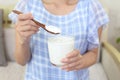 Woman who eats yogurt Royalty Free Stock Photo