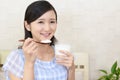 Woman who eats yogurt Royalty Free Stock Photo