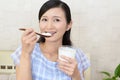 Woman who eats yogurt Royalty Free Stock Photo