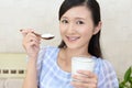 Woman who eats yogurt Royalty Free Stock Photo