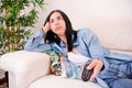 Bored and disengaged woman, searching for something to capture her attention on television at home Royalty Free Stock Photo