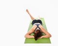 Woman who practices yoga relaxed lying on the mat face down on a white background. Royalty Free Stock Photo
