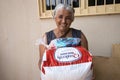 A woman who received a basic food kit donation Royalty Free Stock Photo