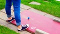 A woman teeing off at miniature golf Royalty Free Stock Photo