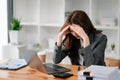 Woman who is tired and overthinking from working with tablet and laptop at modern office Royalty Free Stock Photo