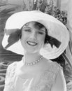 Woman in a wide brimmed hat smiling