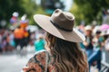 woman in a widebrim hat watching a parade Royalty Free Stock Photo