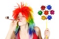 Woman in wig with party blower and pinwheel