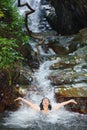 Woman in wild waterfall