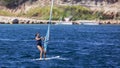 Woman Windsurfing in Blue Waters