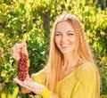 Woman winegrower picking grapes