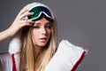 Woman in winter clothes. Portrait of cool young girl in protective helmet and ski mask. Winter time. Attractive Royalty Free Stock Photo