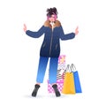 Woman in winter clothes standing near purchases new year christmas shopping seasonal sale concept Royalty Free Stock Photo