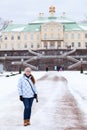 Woman in winter clothes stands in front of the main staircase Menshikov Palace in Oranienbaum