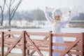 Woman Winter Fashion. Portrait of Sensual Caucasian Blond in Knitted White Dress and Kerchief with Fur Kokoshnik.Posing on Bridge Royalty Free Stock Photo