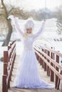 Woman Winter Fashion. Portrait of Sensual Caucasian Blond in Knitted White Dress and Kerchief with Fur Kokoshnik.Posing on Bridge Royalty Free Stock Photo