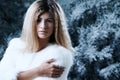Woman, winter and fashion portrait by tree, attitude and pride for fur coat or warm clothes. Female person, serious face Royalty Free Stock Photo