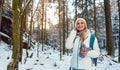 Woman on winter hike enjoying the sunset in the forest Royalty Free Stock Photo