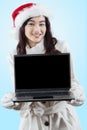 Woman in winter jacket showing laptop Royalty Free Stock Photo