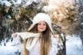 Woman in winter park posing in fur hat and scarf Royalty Free Stock Photo