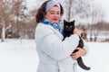 Woman at winter snowy day at walk with a cat Royalty Free Stock Photo