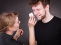 Woman wipe man face by hygienic tissue