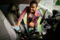 Woman wipes car interior with rag, hand auto wash Royalty Free Stock Photo