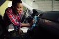 Woman wipes car interior with rag, hand auto wash Royalty Free Stock Photo