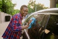 Woman wipes a car with rag, hand auto wash